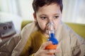 Boy with asthma problems making inhalation with mask on her face Royalty Free Stock Photo