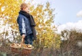 Boy in autumn forest with full basket of mushrooms Royalty Free Stock Photo