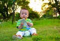 Boy/baby playing mobile phones on the lawn (Asia China)