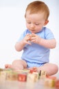Boy, Baby And Playing With Wooden Blocks Or Toys For Childhood Development On A Gray Studio Background. Little Toddler