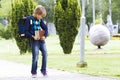 Boy with backpack and books in his hands. Outdoor. Royalty Free Stock Photo