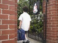 Boy With Backpack Entering School Gate Royalty Free Stock Photo
