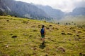 boy with a backpack on a hike against the backdrop of the mountains. child traveler with backpack, hiking, travel, mountains in