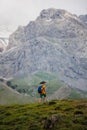 boy with a backpack on a hike against the backdrop of the mountains. child traveler with backpack, hiking, travel, mountains in