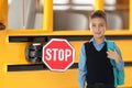 Boy with backpack near school bus. Transport for students Royalty Free Stock Photo