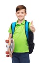 Boy with backpack and skateboard showing thumbs up Royalty Free Stock Photo