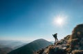 Boy backpacker traveler walk up on mountain top in contrast sun Royalty Free Stock Photo