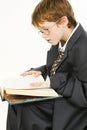 Boy in Baggy Suit Reading Royalty Free Stock Photo