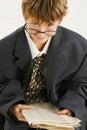 Boy in Baggy Suit Reading Newspaper Royalty Free Stock Photo