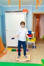 Boy on balancing platform sensory integration