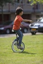 Boy balancing on a unicycle Royalty Free Stock Photo