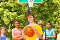 Boy with ball and international friends behind Royalty Free Stock Photo