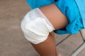 A boy with a bandage on his knees after being injured from playing.