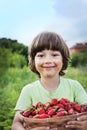 Boy with basket of strawberry Royalty Free Stock Photo