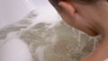 Boy Bathes in Water with Foam in Bathtub, Submerges Under Water, and Emerges