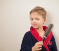 boy in a bathrobe posing at the camera on a white background Royalty Free Stock Photo