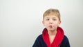 boy in a bathrobe posing at the camera on a white background Royalty Free Stock Photo