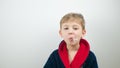 boy in a bathrobe posing at the camera on a white background Royalty Free Stock Photo