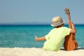 Boy on the beach with ukulele