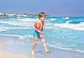Boy on beach wearing inflatable armbands Royalty Free Stock Photo