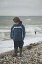 Boy on the beach in winter Royalty Free Stock Photo