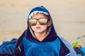 The boy on the beach wrapped in a towel, wet after swimming Royalty Free Stock Photo