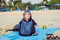 The boy on the beach wrapped in a towel, wet after swimming Royalty Free Stock Photo