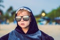 The boy on the beach wrapped in a towel, wet after swimming Royalty Free Stock Photo