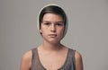 Boy, beanie and fashion in studio for portrait with teenager, edgy and aesthetic by background. Kid, model and hat with Royalty Free Stock Photo