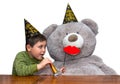 Boy and bear with party favors Royalty Free Stock Photo