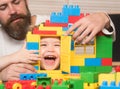 Boy and bearded man play together. Family games concept. Royalty Free Stock Photo