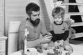 Boy and bearded man play together. Father and son Royalty Free Stock Photo