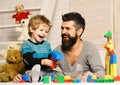 Boy and man play together. Dad and kid with toys Royalty Free Stock Photo