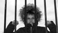 The boy behind bars. Royalty Free Stock Photo
