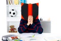 Boy behind a book Royalty Free Stock Photo