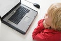 Boy behind laptop Royalty Free Stock Photo