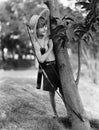 Boy behind tree with bow and arrow