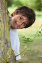 Boy behind tree trunk Royalty Free Stock Photo