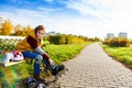 Boy on the bench putting on roller skates Royalty Free Stock Photo