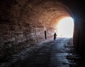 Boy on a bicycle comes out of the tunnel