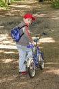 Boy with bicycle glancing back