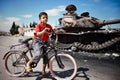 Boy and bicycle with T72 tank, Azaz,Syria. Royalty Free Stock Photo