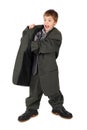 Boy in big man's suit and boots hand in pocket Royalty Free Stock Photo
