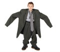 Boy in big man's suit and boots nads at sides Royalty Free Stock Photo