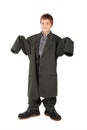 Boy in big man's suit and boots standing isolated Royalty Free Stock Photo