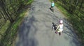 Boy on bike and little girl on rollerskates ride Royalty Free Stock Photo