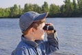 A boy with binoculars