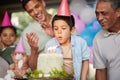 Boy, birthday party and blow candles with cake, celebration and support with applause, hat and happy in family home Royalty Free Stock Photo