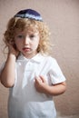 The boy with blond curls in the Jewish yarmulke