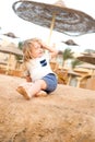 Boy with blond hair have fun on sand Royalty Free Stock Photo